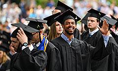 Student waving at commencement